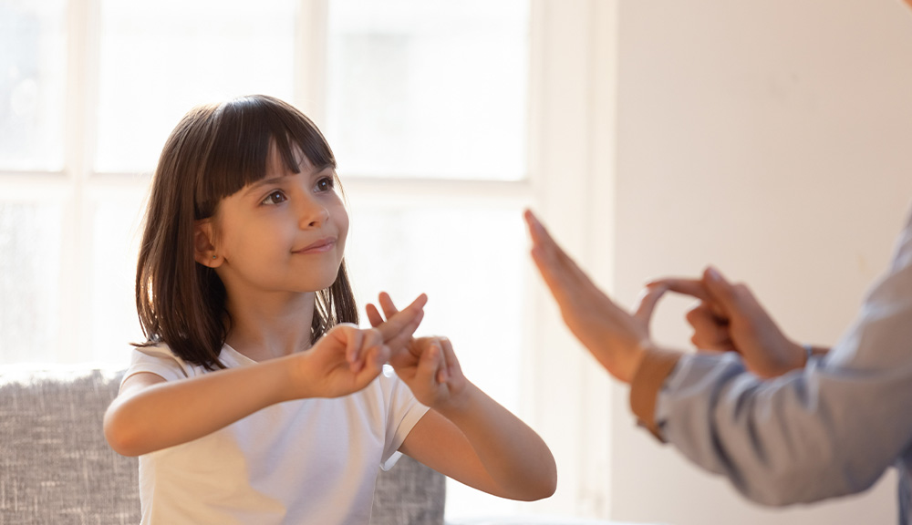 Mom communicating with deaf daughter.